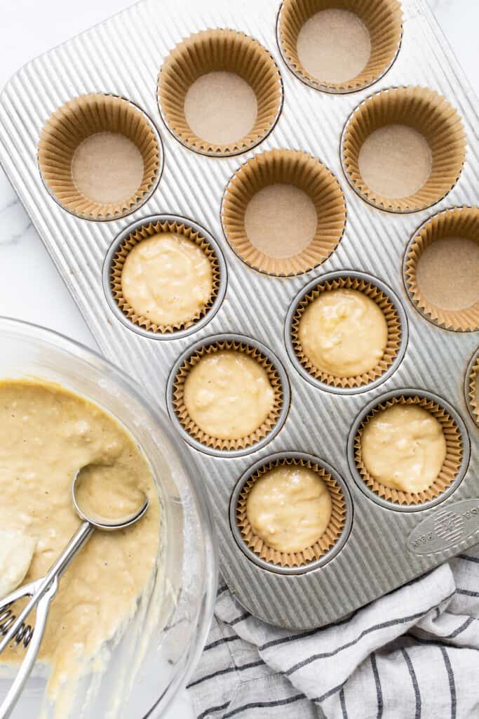 Banana bread muffin batter in muffin tins.