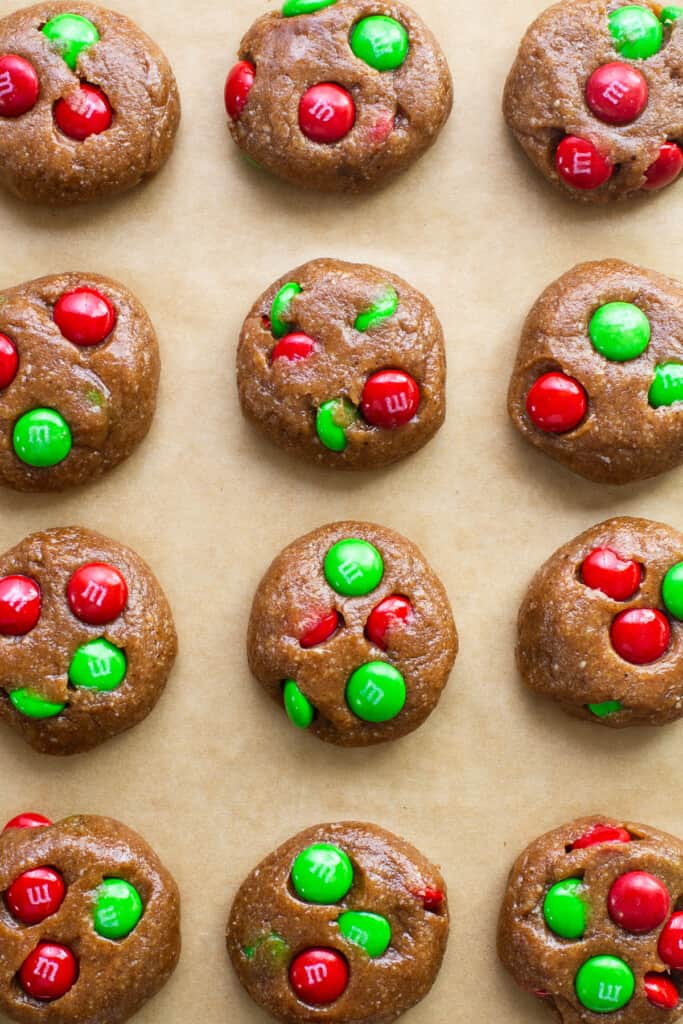 M & m cookies on a baking sheet with green and red m & m's.