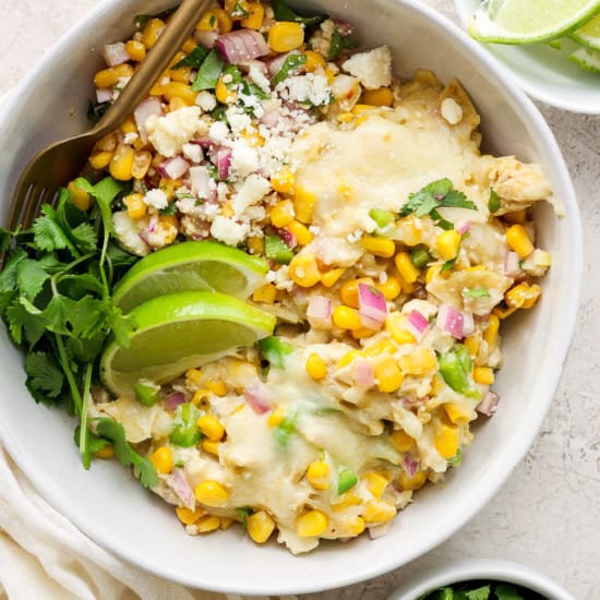 Mexican chicken and corn enchiladas in a white bowl.