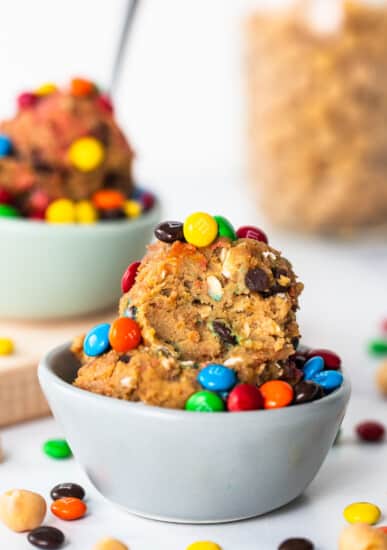 A bowl filled with cookies and m&m's.