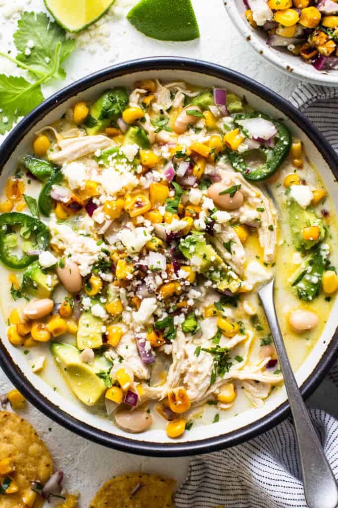 Mexican chicken soup in a bowl with tortilla chips.