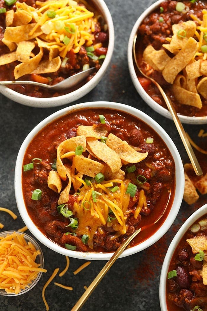 bowl of beef chili with cheese on top.