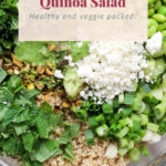 A bowl of green goddess quinoa salad containing quinoa, avocado, edamame, chopped kale, green onions, fresh herbs, and topped with a dressing and crumbled cheese.