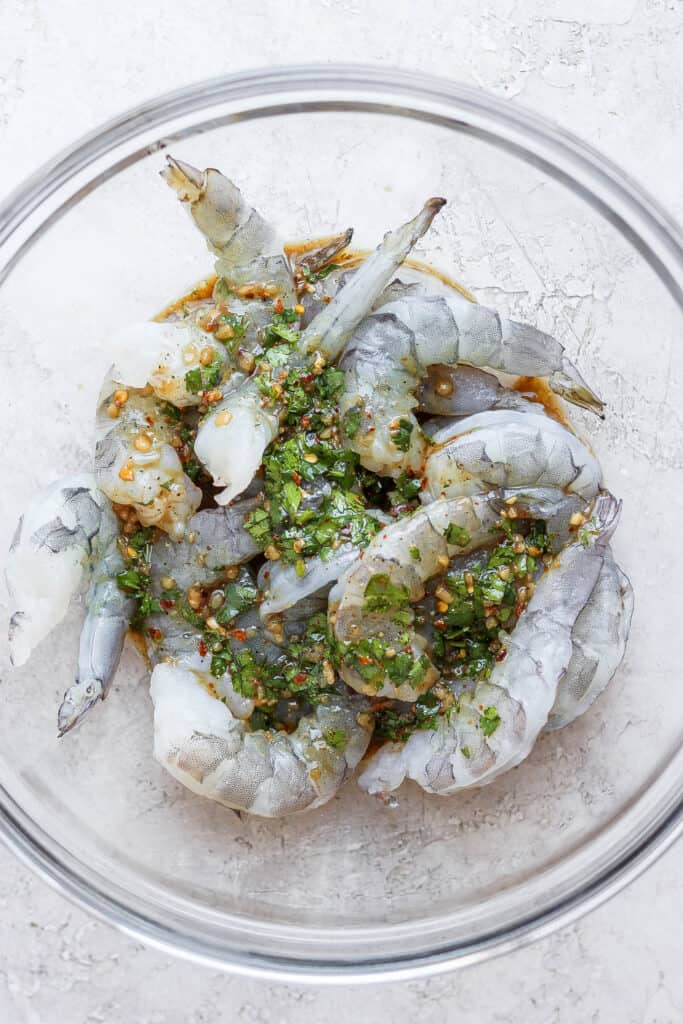 raw shrimp marinating in bowl.